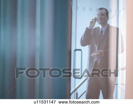 Stock Photo - Businessman on phone in office. Fotosearch