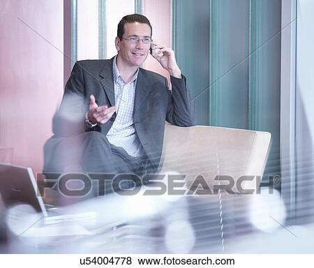 Businessman on phone in office View Large Photo Image Stock Photo - Businessman on phone in office. Fotosearch