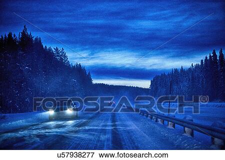"Car headlights on snow covered highway at dusk, Hemavan, Sweden" View Large Photo Image Stock Photo - "Car headlights on snow covered highway at dusk, Hemavan, Sweden". Fotosearch