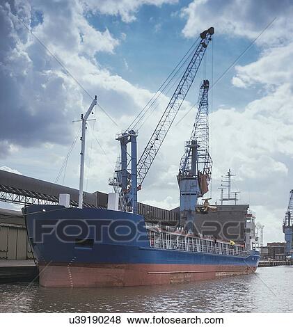 Stock Photo - Cargo ship moored at port. Fotosearch