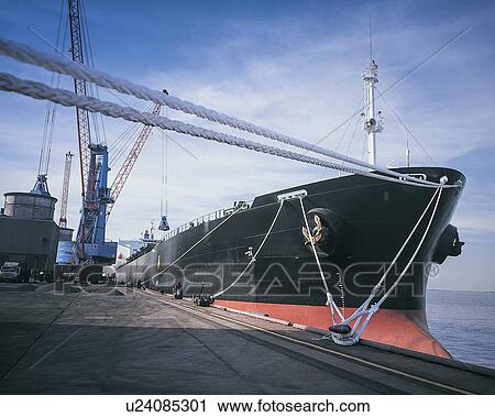 Cargo ship moored with ropes at port View Large Photo Image Stock Image - Cargo ship moored with ropes at port. Fotosearch