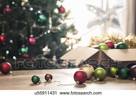 Stock Image - Christmas baubles on table. Fotosearch
