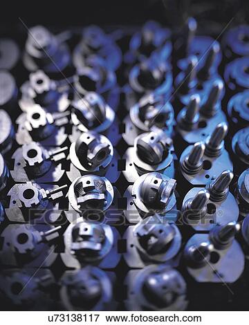 Stock Photo - Close up of metal parts in factory. Fotosearch