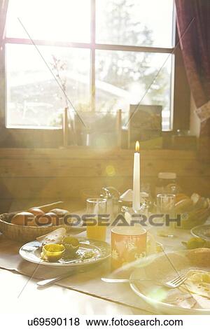 Stock Photo - Close up of sunlit breakfast table in log cabin. Fotosearch