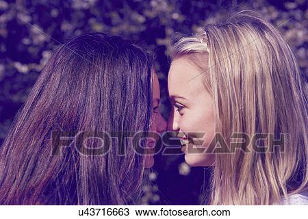 Close up portrait of two girls face to face View Large Photo Image Stock Image - Close up portrait of two girls face to face. Fotosearch