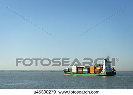Stock Photo - "Containership sailing on Westerschelde river, towards Antwerp harbour, Riland, Zealand, Netherlands". Fotosearch