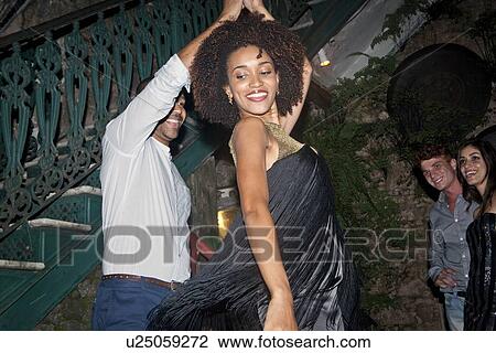 "Couple dancing outdoors, friends looking on" View Large Photo Image Stock Image - "Couple dancing outdoors, friends looking on". Fotosearch