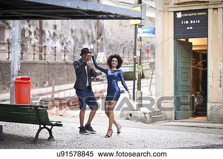 Stock Photography - "Couple dancing outdoors, smiling". Fotosearch
