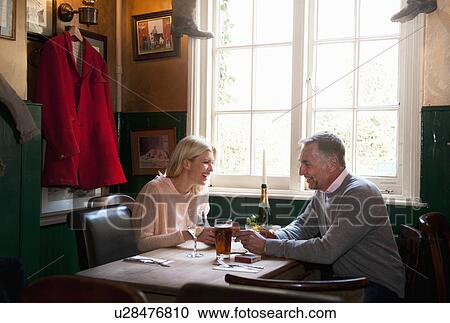 Couple drinking and chatting in pub View Large Photo Image Stock Image - Couple drinking and chatting in pub. Fotosearch