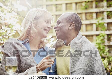 Couple drinking wine in garden View Large Photo Image Stock Photo - Couple drinking wine in garden. Fotosearch