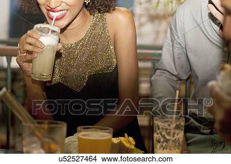"Couple enjoying drinks in bar, mid section" View Large Photo Image Picture - "Couple enjoying drinks in bar, mid section". Fotosearch