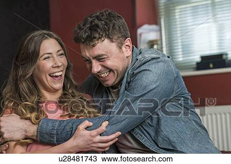 Couple hugging and laughing View Large Photo Image Stock Image - Couple hugging and laughing. Fotosearch
