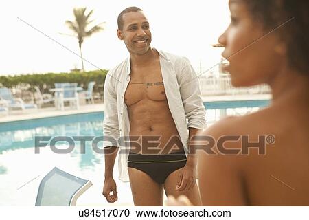 "Couple in swimwear at hotel swimming pool, Rio De Janeiro, Brazil" View Large Photo Image Stock Image - "Couple in swimwear at hotel swimming pool, Rio De Janeiro, Brazil". Fotosearch