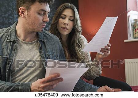 Stock Photo - Couple looking at paperwork. Fotosearch
