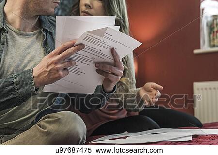 Stock Photography - Couple looking at paperwork. Fotosearch