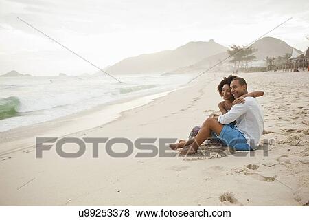 "Couple sitting on beach, Rio De Janeiro, Brazil" View Large Photo Image Stock Photo - "Couple sitting on beach, Rio De Janeiro, Brazil". Fotosearch