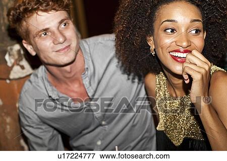 "Couple sitting together in bar, smiling" View Large Photo Image Stock Photo - "Couple sitting together in bar, smiling". Fotosearch