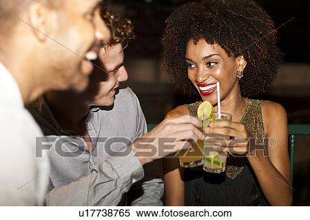 "Couple sitting together in bar, smiling" View Large Photo Image Stock Photography - "Couple sitting together in bar, smiling". Fotosearch