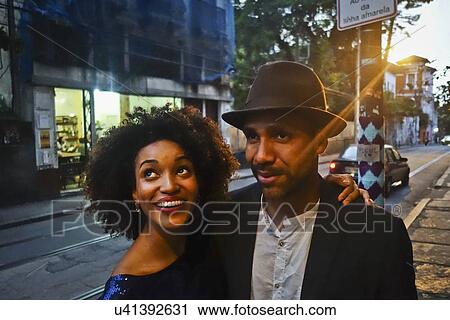 "Couple standing together in urban environment, smiling" View Large Photo Image Stock Image - "Couple standing together in urban environment, smiling". Fotosearch