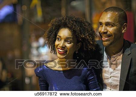 "Couple standing together, outdoors, at night, looking away" View Large Photo Image Stock Image - "Couple standing together, outdoors, at night, looking away". Fotosearch