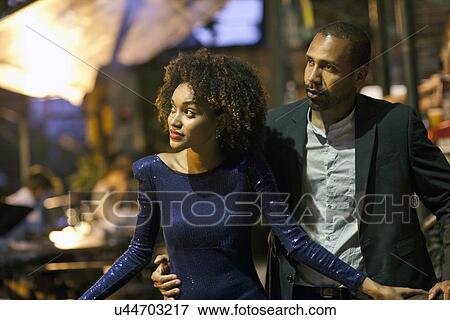 "Couple standing together, outdoors, at night, looking away" View Large Photo Image Stock Photo - "Couple standing together, outdoors, at night, looking away". Fotosearch