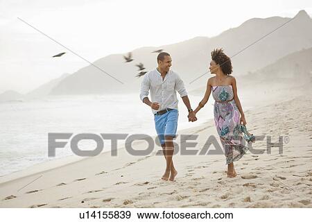 "Couple strolling on beach, Rio De Janeiro, Brazil" View Large Photo Image Stock Photo - "Couple strolling on beach, Rio De Janeiro, Brazil". Fotosearch