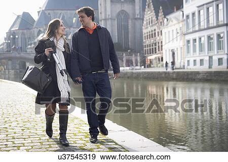 "Couple strolling on Leie riverside, Ghent, Flanders, Belgium" View Large Photo Image Stock Photo - "Couple strolling on Leie riverside, Ghent, Flanders, Belgium". Fotosearch