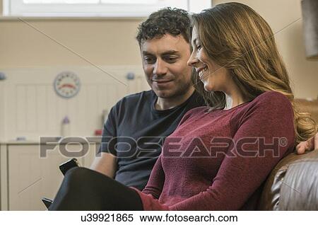 Stock Photography - Couple using smartphone. Fotosearch