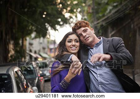 "Couple walking along street, arms around each other, smiling" View Large Photo Image Stock Image - "Couple walking along street, arms around each other, smiling". Fotosearch