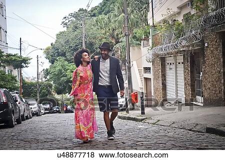 "Couple walking down cobbled street, smiling" View Large Photo Image Stock Photo - "Couple walking down cobbled street, smiling". Fotosearch