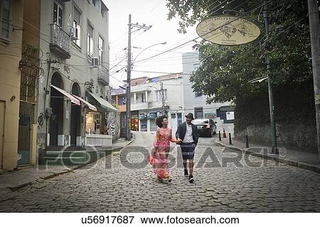 Stock Photo - "Couple walking down cobbled street, hand in hand". Fotosearch
