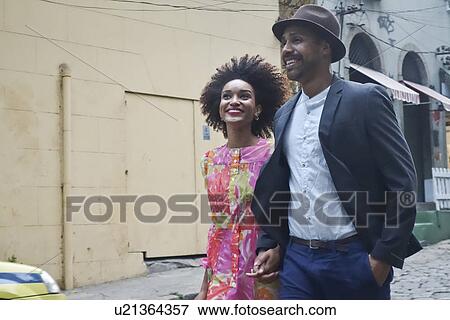 "Couple walking down street, hand in hand" View Large Photo Image Stock Photo - "Couple walking down street, hand in hand". Fotosearch