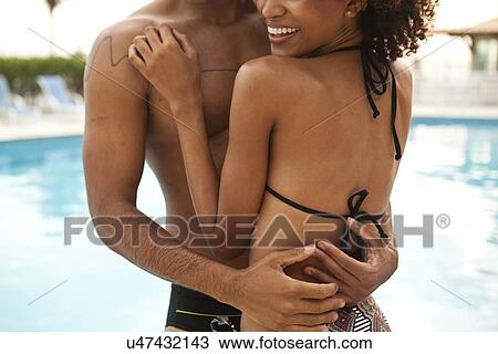 "Cropped shot of couple hugging at hotel poolside, Rio De Janeiro, Brazil" View Large Photo Image Stock Image - "Cropped shot of couple hugging at hotel poolside, Rio De Janeiro, Brazil". Fotosearch