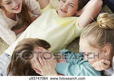 Cropped view of five boys and girls fooling around laughing View Large Photo Image Picture - Cropped view of five boys and girls fooling around laughing. Fotosearch