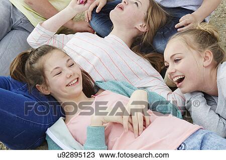 Cropped view of five boys and girls lying on ground View Large Photo Image Stock Image - Cropped view of five boys and girls lying on ground. Fotosearch