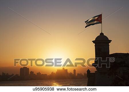 Stock Photo - "Cuban flag over the Fortress of El Morro at sunset, Havana, Cuba". Fotosearch
