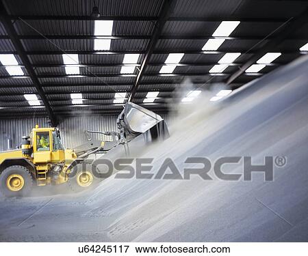 Stock Photo - Digger loading bulk fertilizer in port. Fotosearch