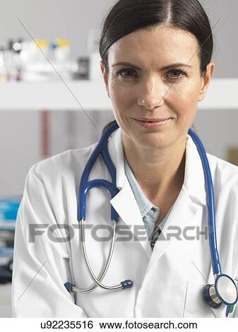 Doctor at desk awaiting patient View Large Photo Image Stock Photograph - Doctor at desk awaiting patient. Fotosearch