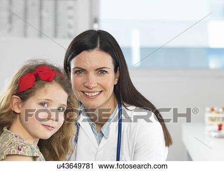 Doctor bonding with young girl during consultation View Large Photo Image Stock Image - Doctor bonding with young girl during consultation. Fotosearch