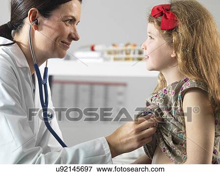 Doctor bonding with young girl during consultation View Large Photo Image Stock Photo - Doctor bonding with young girl during consultation. Fotosearch