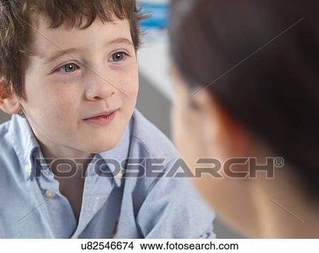 Doctor comforting young boy in clinic View Large Photo Image Picture - Doctor comforting young boy in clinic. Fotosearch