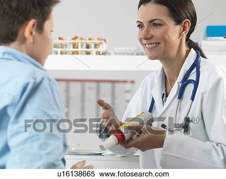 Doctor explaining lung function test to young boy in clinic View Large Photo Image Stock Photography - Doctor explaining lung function test to young boy in clinic. Fotosearch