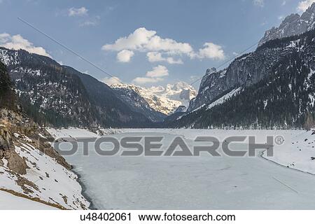 "Elevated view of frozen lake and snow covered mountains, Gosausee, Austria" View Large Photo Image Stock Image - "Elevated view of frozen lake and snow covered mountains, Gosausee, Austria". Fotosearch
