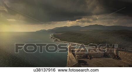 Stock Photograph - "Elevated view of storm clouds from San Pedro de la Roca Castle, Santiago de Cuba, Cuba". Fotosearch