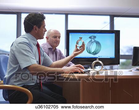 Engineer and client inspecting automotive part at desk View Large Photo Image Stock Photography - Engineer and client inspecting automotive part at desk. Fotosearch