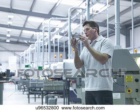 Engineer inspecting part on production line View Large Photo Image Stock Image - Engineer inspecting part on production line. Fotosearch
