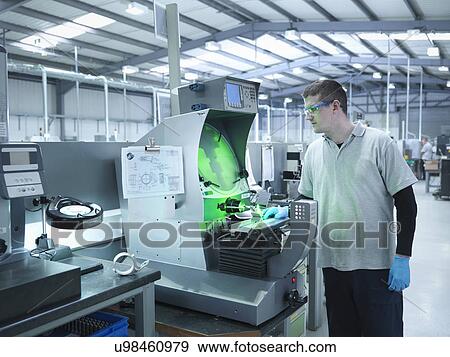 Stock Photo - Engineer inspecting product with shadow graph machine. Fotosearch