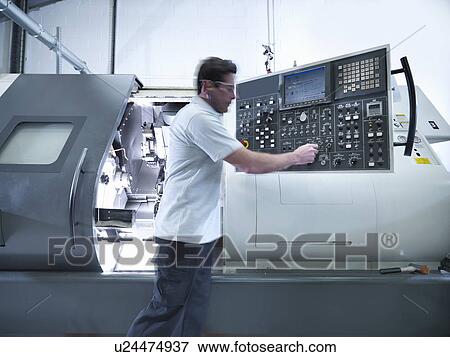 Engineer operating CNC lathe in factory View Large Photo Image Stock Photo - Engineer operating CNC lathe in factory. Fotosearch