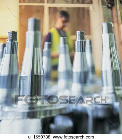 Stock Photo - Engineer with steel parts in foreground. Fotosearch