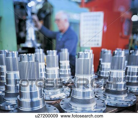 Stock Photo - Engineer with steel parts in foreground. Fotosearch